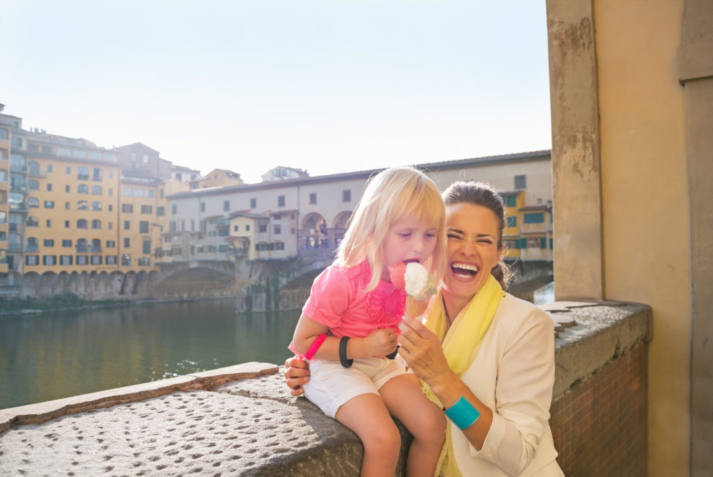 Mother and daughter eating gelato in Italy