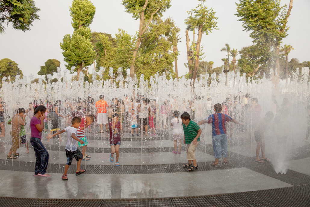 Locals and tourists playing in the fountain in Lima, Peru