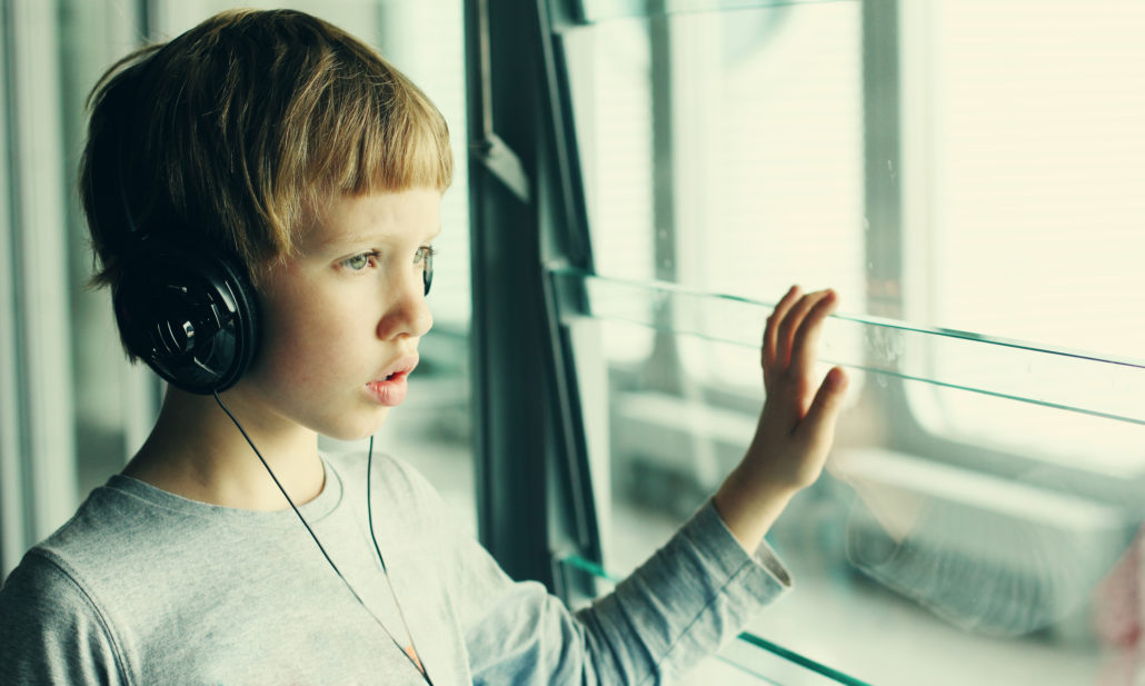 Young boy at airport with headphones