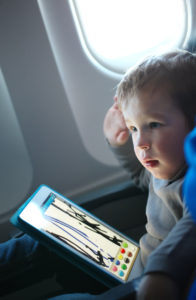 boy with iPad on Airplane