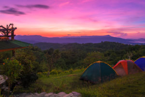 Camping tent in campground at national park with sunrise.