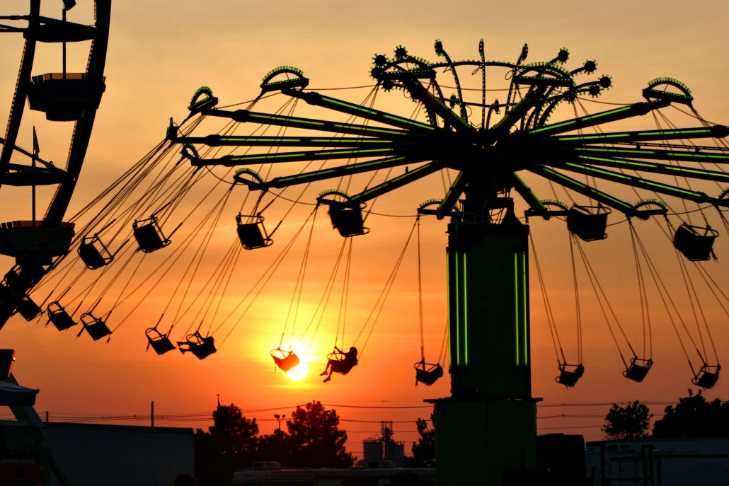 Swing ride at the kentucky state fair silhouetted against the setting sun