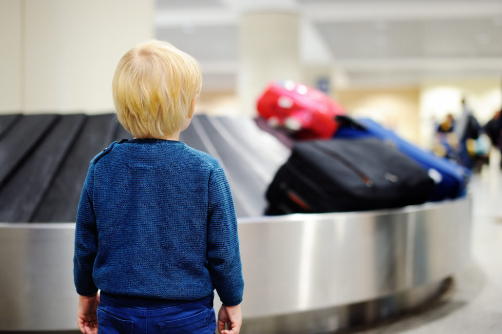 Kid at airport waiting for luggage