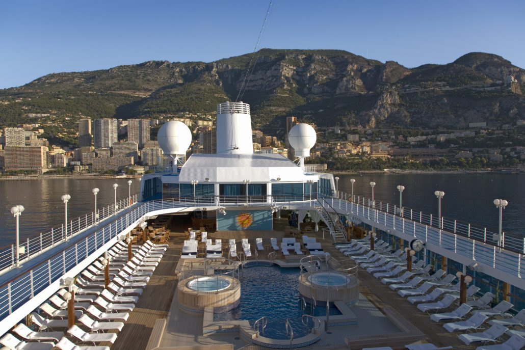 Upper deck swimming pool of Insignia Oceania Cruise ship as it cruises Mediterranean Ocean, Europe