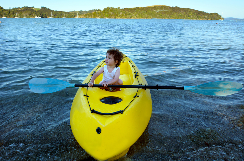 Little girl on a yellow Kayak in New Zealand