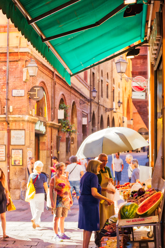 Tourists and locals go shopping in medieval market, Quadrilatero. The Quadrilateral Area, was born in Middle Ages, Bologna, Italy © GoneWithTheWind | Dreamstime.com