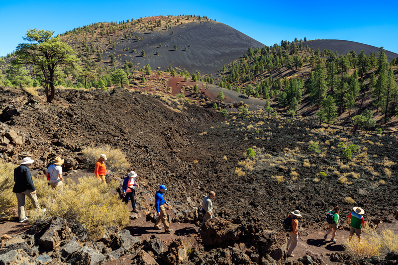 Hiking crystallized lava flow at the Sunset Crater Volcano in Flagstaff, Arizona. Photo: Fotoluminate | Dreamstime.com