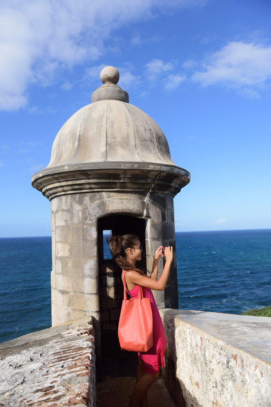 Woman in Puerto Rico taking pictures in Old San Juan Fort Castillo San Felipe Del Morro. Photo: Martinmark - Dreamstime.com